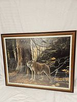 Full view of the framed cougar print leaning against a white backdrop.
