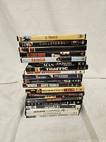 Photo showing stack of 19 DVDs with mob and gang movie titles visible