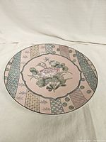 Top view of the vintage pink floral plate showing detailed floral design and patterned border.