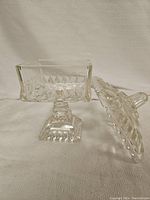 Square glass candy dish with lid removed, showing interior and pedestal base details