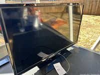 Front view of the 32-inch LED TV showing screen and stand.