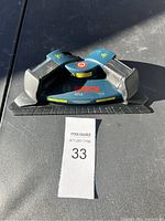 Front view of the Bosch GTL2 laser level on a dark surface with light reflecting, showing general condition and markings.