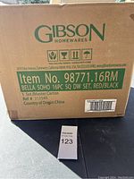 Box label showing item number 98771.16RM and details: Bella Soho 16-piece square dinnerware set, red/black, made in China
