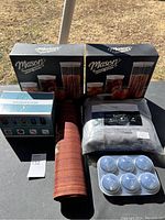 Overview of all household items showing two Mason storage sets, Snackeez box, rolled placemats, gray pillow, and LED tea lights.