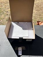 Boxed set showing white foam padding and instruction manual inside box.