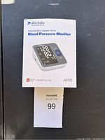 Front view of the Alcedo blood pressure monitor box showing product image and model AE176