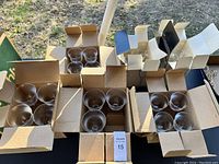 Photo of multiple Mikasa crystal wine glasses grouped in cardboard boxes, totaling 23 glasses with one missing.