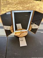 Front view of the tri-fold light up vanity mirror showing three mirror panels and gold-colored base.
