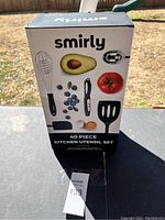 Image of Smirly brand 40 piece kitchen utensil set box, showing images of avocado, tomato, blueberries, and some utensil illustrations.