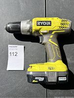 Side view of Ryobi cordless drill showing general wear and battery attached