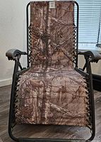 Camo lawn chair front-facing view showing fabric pattern and armrests
