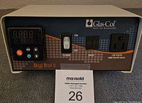 Front view of Glas-Col Digi Trol II heating mantle controller unit showing power switch, digital control panel, two electrical outlets, and branding on blue and brown front panel.