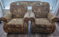 Front view of two matching recliner chairs side by side showing patterned upholstery and overall shape.
