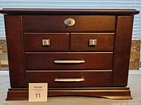 Front view of solid cherry wood men's jewelry box with lock and satin silver-tone handles.