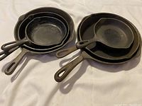 Photo showing all six cast iron skillets nested together to display size and quantity.
