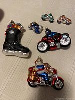 Photo showing Harley-Davidson boot ornament alongside several colorful glass motorcycles in multiple sizes