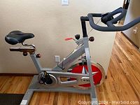 Full side view of Sunny Pro SF-B901 indoor cycling bike showing frame, seat, handlebars, and flywheel.