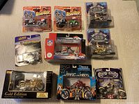 Top view showing all 10 motorcycles in their original boxes arranged flat on a tabletop, clearly displaying the branded packaging and model names.