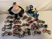 Overview of plush pig with several toy motorcycles and riders around it