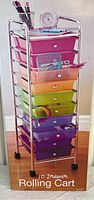 Photo showing the full colorful 10 drawer rolling cart with items on top, indicating size and design.
