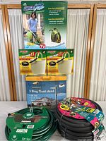 Full view of all items including water hoses, hose holders, and plant stand.