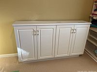 Front view showing closed cabinet with four doors