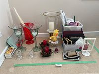 Overview of all items including candles, candle holders, picture frames, wreaths, and red plastic vase.