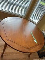 Top view of the round wooden table showing perimeter detail and condition.