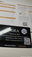 Certificate and warranty card from GRA showing authenticity and warranty ID