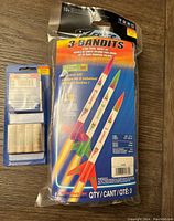 Sealed 3 Bandits flying model rocket kit packaging showing three colorful rockets and flight details.