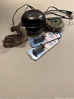 Lot displayed showing Aquascape pond aerator, round air pump, two unused bubble air stones in packaging, and koi fish decoration