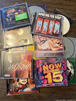 Photo showing 10 music CDs including Good Charlotte, Bowling for Soup, Ja Rule, and NOW That's What I Call Music! 15.