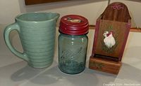 View of all three items: Weller milk pitcher, Ball jar with duck lid, and rooster match holder