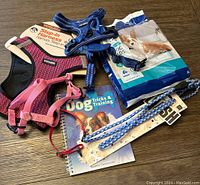 Full lot showing harnesses, leash, collar, puppy pads, and training book