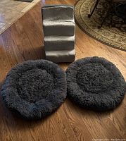Photo of two dark gray shaggy round cuddler pet beds and beige Animal Planet soft pet steps on a wood floor