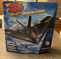 Box of Air Hogs R/C Dominator plane showing the product and key features on the front including flight range and controller.
