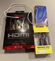 Rocketfish HDMI cable new in box, Connect Onn USB-C to Lightning cable in packaging, blue patterned iPhone case