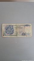 Front side of the 50 Drachmai banknote showing classical Greek artwork and denomination.