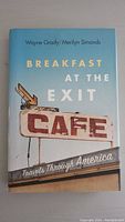 Front cover of the book showing the title, authors, and a cafe sign image.