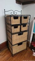Front and side views of the wicker storage unit with metal frame showing six drawers with cutout handles.