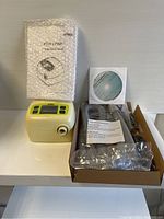 CPAP device, bubbled instruction manual, compliance CD and open box with tubing and cord
