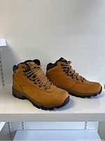 Side view of tan Hi-Tec hiking boots showing profile and outsoles