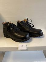 Side and angled view showing overall shape, lace-up design, and padded collar of the boots.