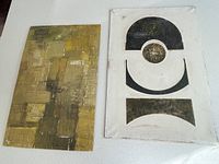 Two Geoffrey Armstrong abstract paintings on board displayed on table, showing size and style difference.
