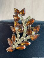 Close-up of front view showing brown marquise-cut stones and clear rhinestones in floral/leaf design.
