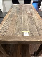 Top view of the barn-wood dining table showing wide plank surface with natural wood grain and varied tones.