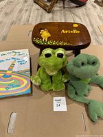 Books and toys with personalized bench showing painted girl, balloon, flowers, and name