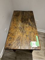 Overhead view of desk top showing plank-style wood surface with knots and cracks