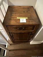 Top front view of the cabinet showing drawer and door with label listing dimensions.