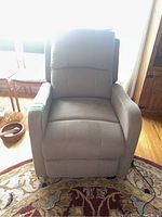 Front view of grey electric recliner, arms and seat visible